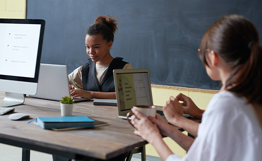 students working at desk in classroom